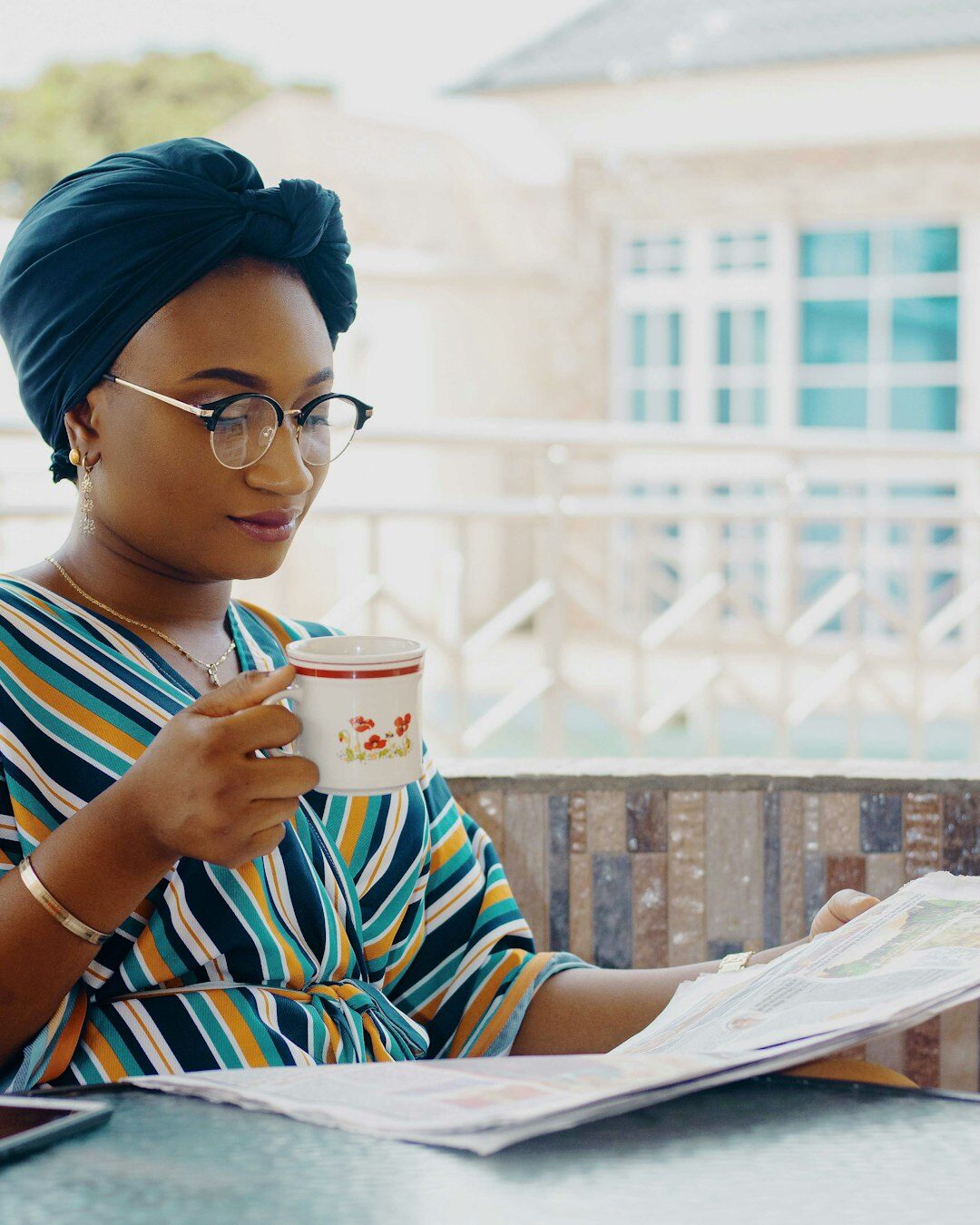 European businesswoman reviewing documents and taking notes on a tablet at her desk